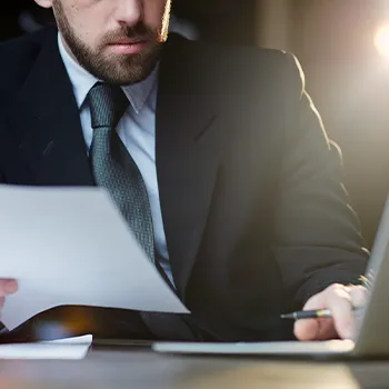 A man organizing paperwork for managing compliance documents