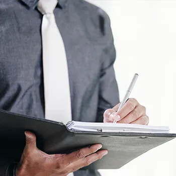 An agent working and writing on a folder full of important documents