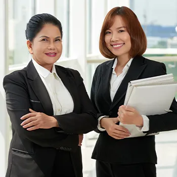 Two professional women smiling at the camera