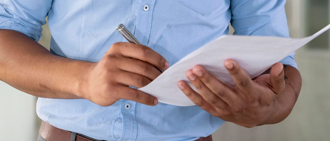 Venture Smarter | Virginia LLC Operating Agreement + Free Template A man writing a Virginia LLC operating agreement