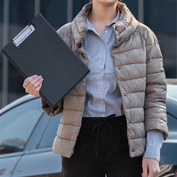 Woman holding her documents outdoors passing it to the state