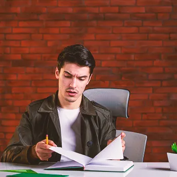 A man looking at a log book