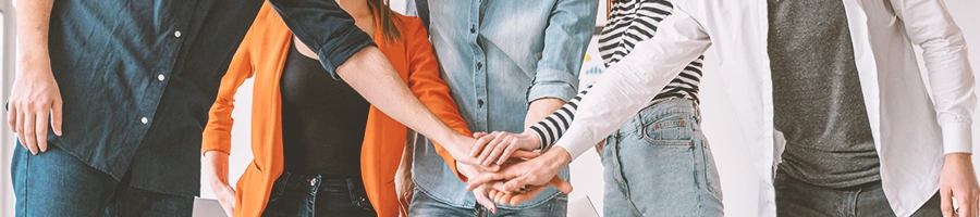 Office workers joining hands