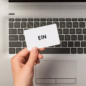 A small white card with EIN written