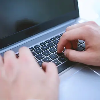 A man looking up an LLC in Nebraska on laptop