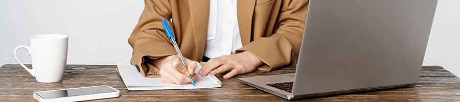 An image of a woman writing down the LLC formation process in Pennsylvania