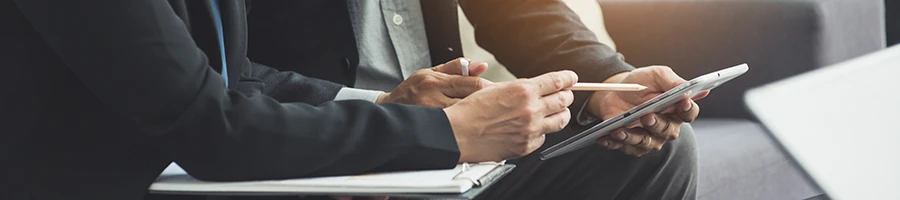 Two professionals talking about the needed requirements for Arkansas registered agent services