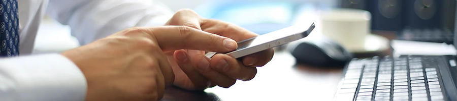 A business man writing a testimonial using a smartphone