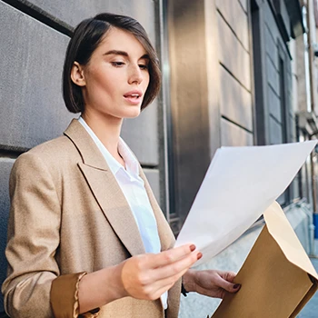 A business woman reading the certificate of status