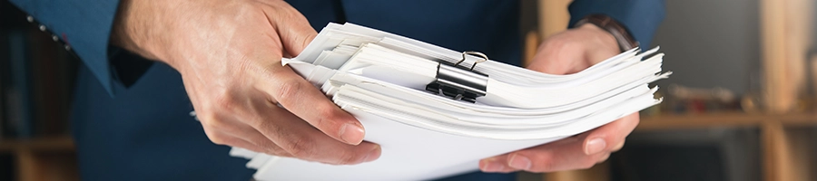 Venture Smarter | How to Change an LLC Name in Tennessee? (Simple Guide) Organizing a stack of clipped papers about changing an LLC name in Tennessee